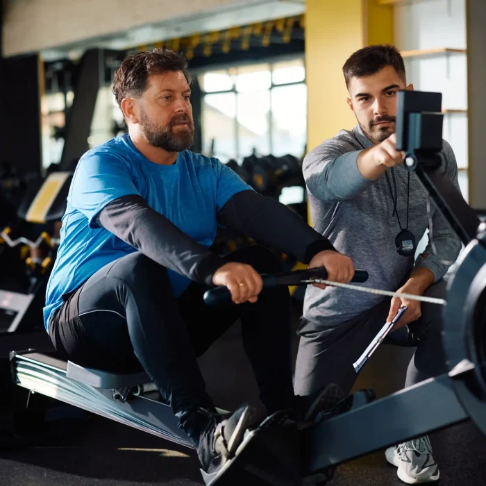 mature-athlete-man-using-rowing-machine-during-exe-2024-12-13-20-19-26-utc